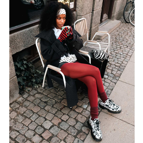 Model Wearing Dr Martens Buzz Dalmatian Hair On 5 Eyes Platform Shoes - Sitting on Chair