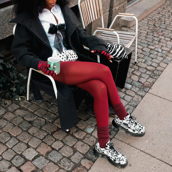 Model Wearing Dr Martens Buzz Dalmatian Hair On 5 Eyes Platform Shoes - Sitting Outside Cafe
