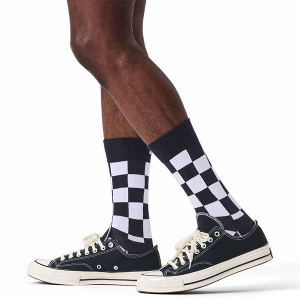 Man wears Happy Socks Mod Checkerboard Socks in Black/White P004536