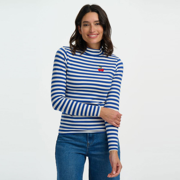 Woman wears Sugarhill Brighton Cherry Annika Turtleneck Jersey Top in Off White/Blue Stripes