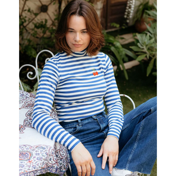 Women wearing Sugarhill Brighton Cherry Annika Turtleneck Jersey Top in Off White/Blue Stripes sitting at a cafe table