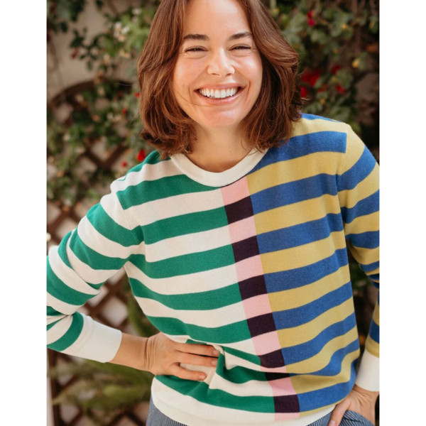 Lifestyle photo of smiling woman wearing Sugarhill Brighton Off-Set Stripe Retro Rosie Knitted Jumper