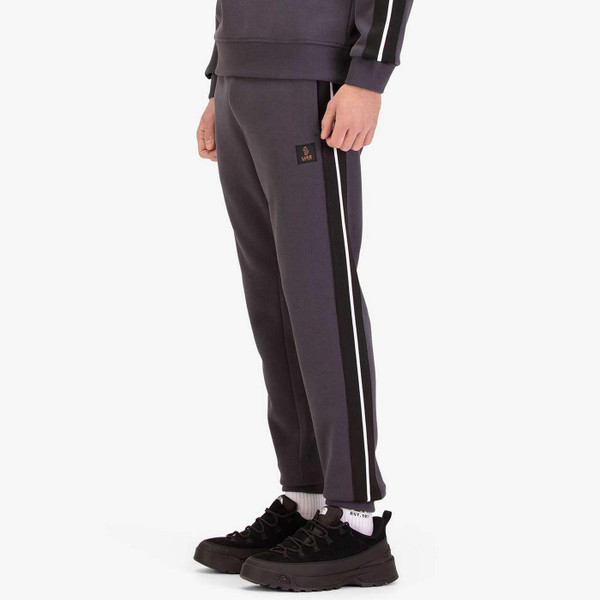 Model Wearing Luke Cornell 1000 Men's Retro Stripe Tape Joggers in Charcoal - Side