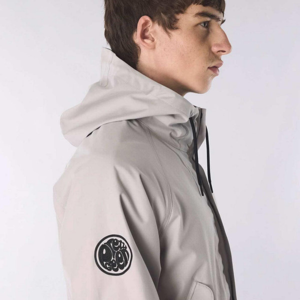 Model Wearing the Pretty Green Resonance Water Reactive Paisley Hooded Jacket in Grey - Badge Detail