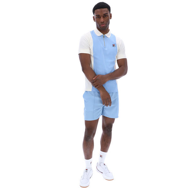 Man wearing Fila Vintage Pierro Men’s Zip Neck Polo in Blue/Off White