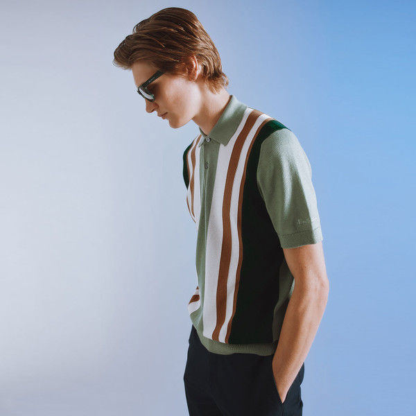 Lifestyle photo of man wearing Ben Sherman Vertical Stripe Men's Mod Knitted Polo Shirt in Sage Green side view