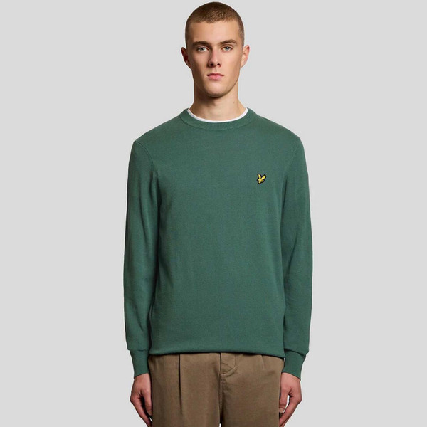 Model Wearing Lyle and Scott Men's Retro Cotton Crew Neck Jumper in Everglade Green