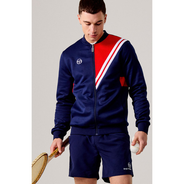 Man with tennis racquet wearing Sergio Tacchini New Reno 80s Vitas Gerulaitis Retro Track Top in Maritime Blue & Red
