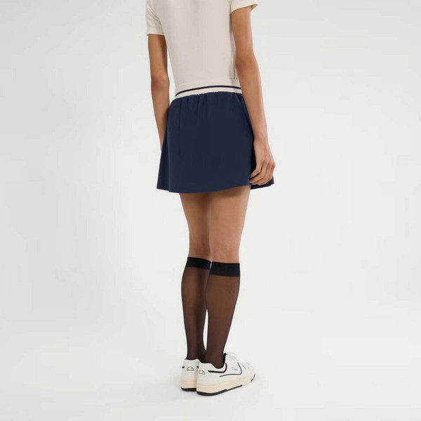 Model Wearing Ellesse Bromont Women's Retro Tennis Skort in Navy and White - Back View