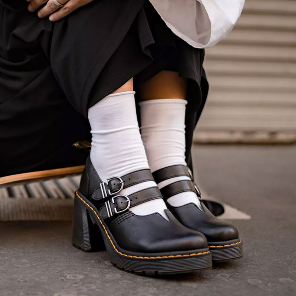 Woman wearing Dr Martens Eviee Women's Retro 90s 2 Strap Heel Sandals in Black Leather