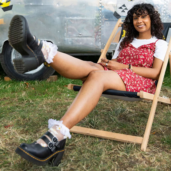 Woman wears Dr Martens Eviee Women's Retro 90s 2 Strap Heel Sandals in Black Leather