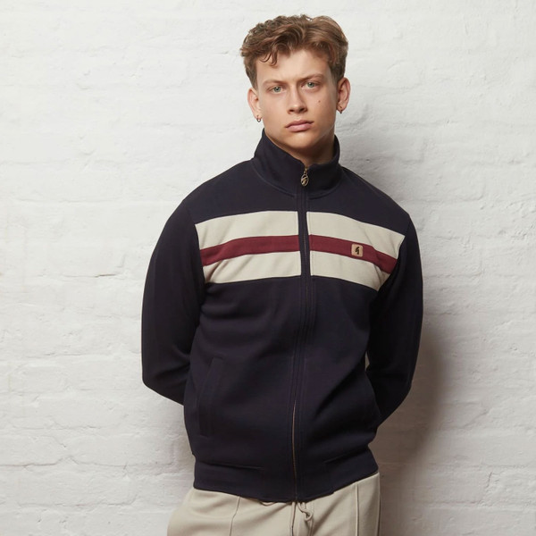 Man wearing Gabicci Vintage Escher Men's Retro Funnel Neck Chest Stripe Track Top in Navy