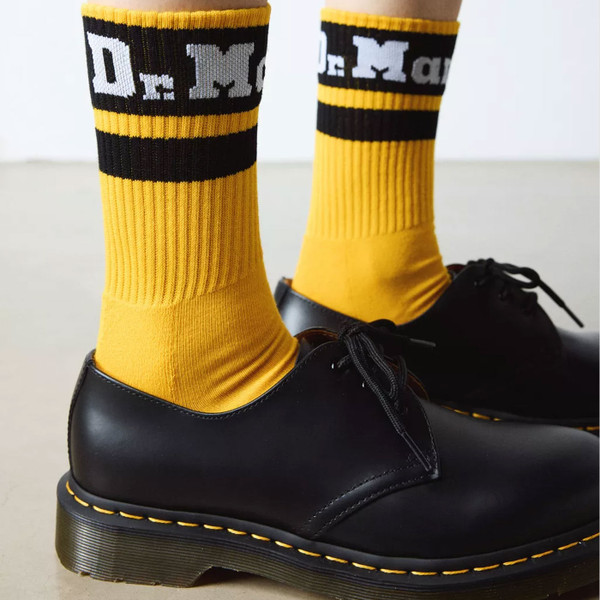 Person wearing Dr Martens Retro Athletic Logo Socks in Yellow AC681700