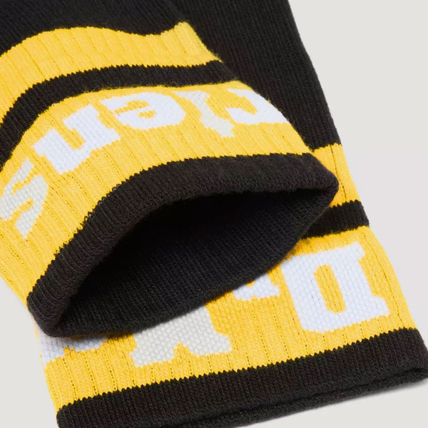Top of Dr Martens women's AC681005 Athletic Logo Sock in Black and yellow