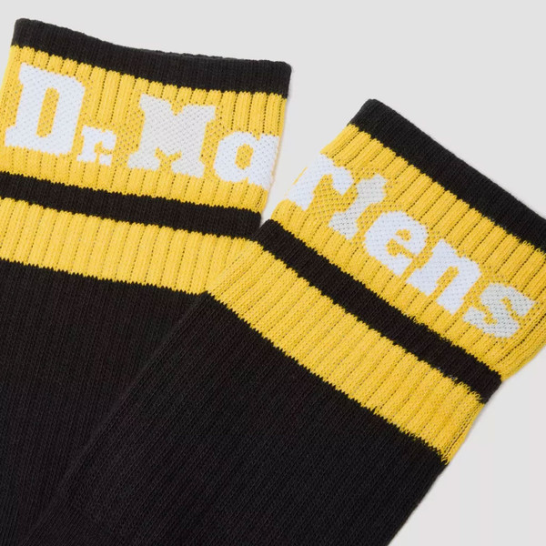 top of Dr Martens women's AC681005 Athletic Logo Sock in Black and yellow