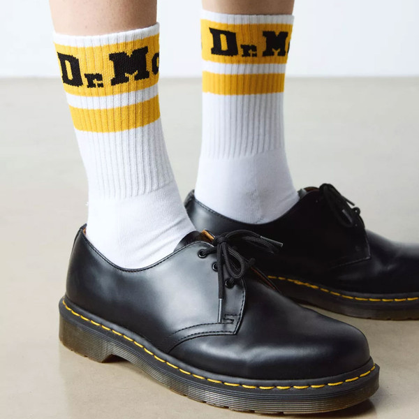 Person wearing Dr Martens Women's Athletic Logo Socks in White/Yellow AC681103