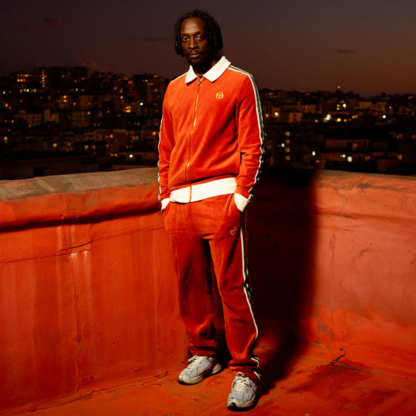 Man wearing Sergio Tacchini Monte Retro 80s Velour Track Jacket in Rust Orange