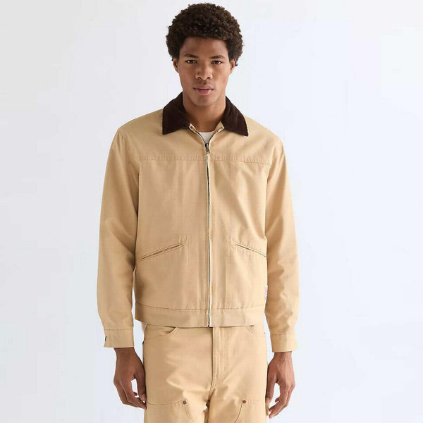 Model Wearing Wrangler Men's Retro Transitional Cord Collar Canvas Jacket in Golden Wheat
