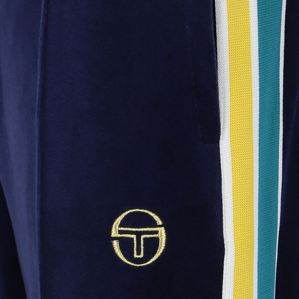 Side stripes and pocket on Sergio Tacchini Monte Velour Retro Tracksuit Pants in Navy