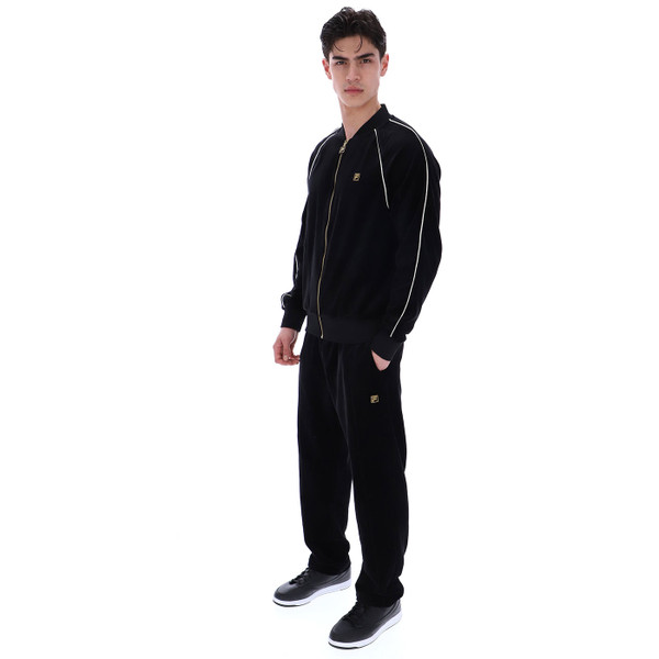Man wears Fila Gold Fella Retro 70s Velour Bomber Track Jacket in Black