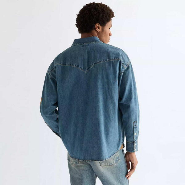 Model Wearing Wrangler Men's Retro 1980s Oversized Denim Western Shirt with Embroidery in Trail Blazer Blue - Back View