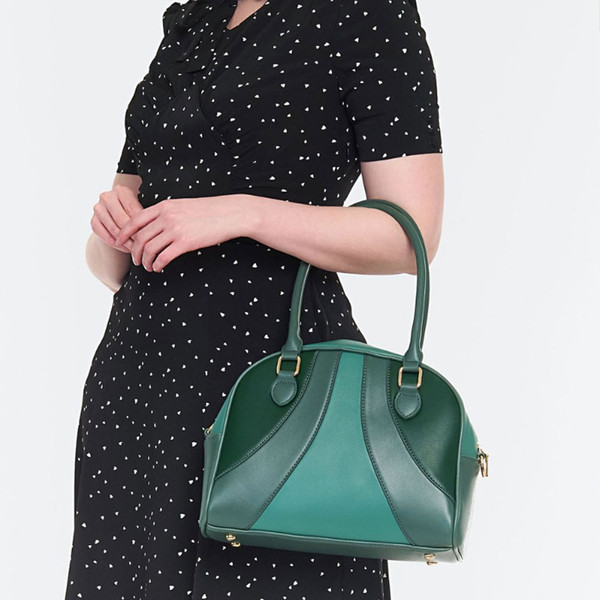 Model holding Voodoo Vixen Retro Mod Bowling Bag in Green on arm