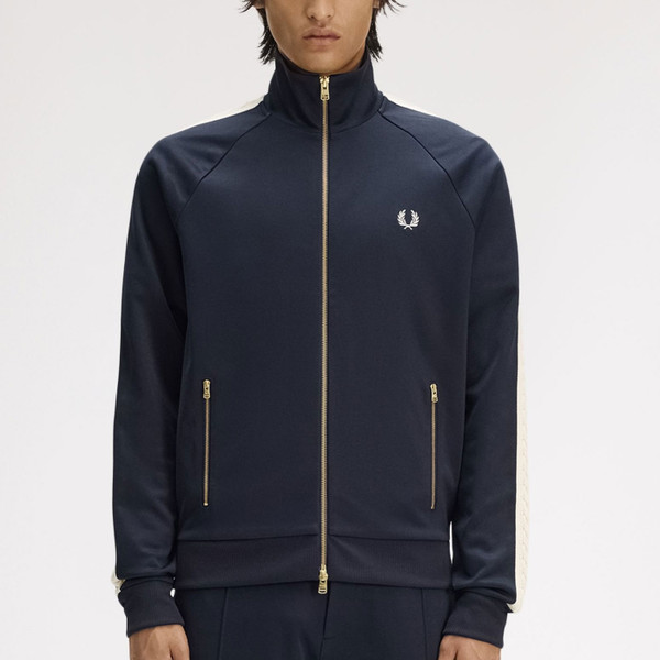 Man wearing Fred Perry Men's Retro Cable Taped Sleeve Track Jacket in Navy