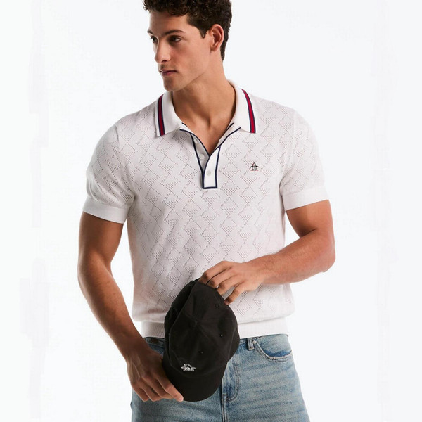 Model Wearing Original Penguin Men's Geometric Eyelet Sweater Polo in Bright White Front Facing Holding Cap