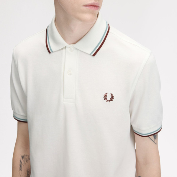 Model Wearing Fred Perry M3600 Mod Twin Tipped Polo Shirt in Snow White/Silver Blue/Brandy - Chest Close Up