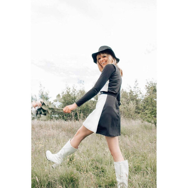 Side view of model wearing the Madcap England Golightly black and white mini dress