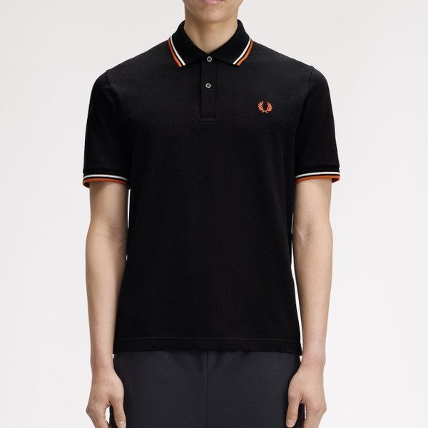 Model Wearing Fred Perry M12 Twin Tipped Polo Shirt in Black, Tramline White and Summer Clay - Front Facing