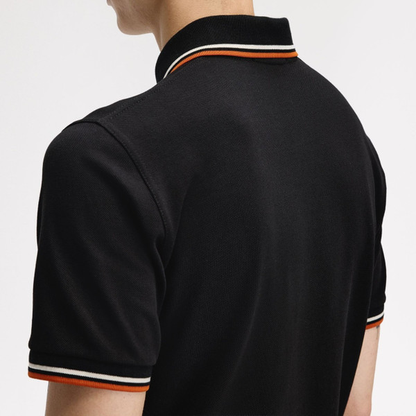Model Wearing Fred Perry M12 Twin Tipped Polo Shirt in Black, Tramline White and Summer Clay - Back Close Up