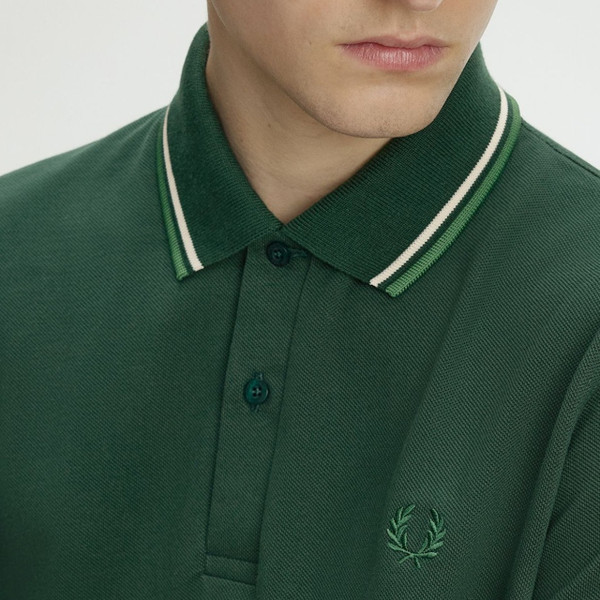 Model Wearing Fred Perry M12 Twin Tipped Polo Shirt in Grassroots, Tramline White and Ace Green - Laurel Wreath Close Up