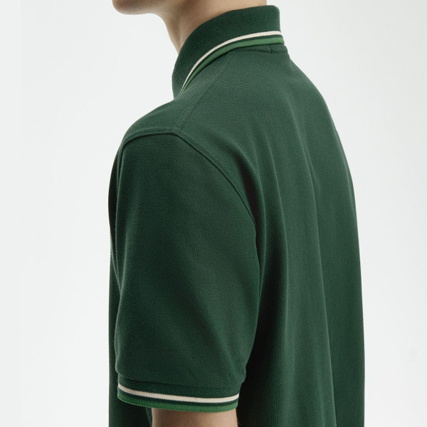 Model Wearing Fred Perry M12 Twin Tipped Polo Shirt in Grassroots, Tramline White and Ace Green - Twin Tipping Close Up