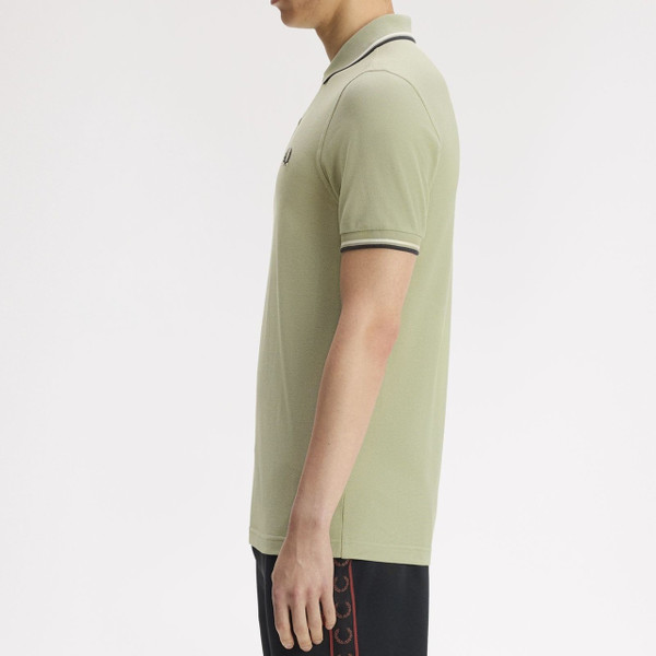 Model Wearing Fred Perry M3600 Mod Twin Tipped Polo Shirt in Seagrass / Ecru / Dark Airforce - Side On