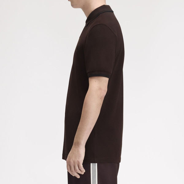 Model Wearing Fred Perry M3600 Mod Twin Tipped Polo Shirt in Rich Brown / Black - Side On