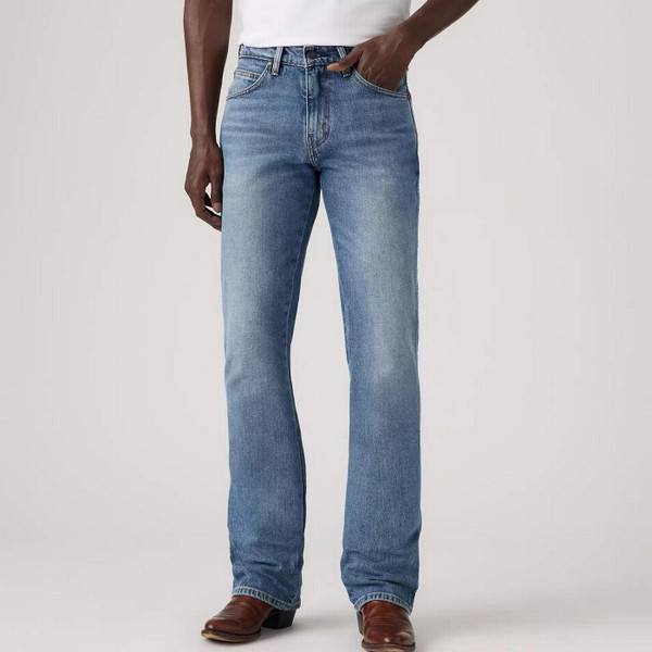 Model Wearing Levi's Men's 537 Western Bootcut Medium Wash Blue Denim Jeans in Throw The Lasso - Front 