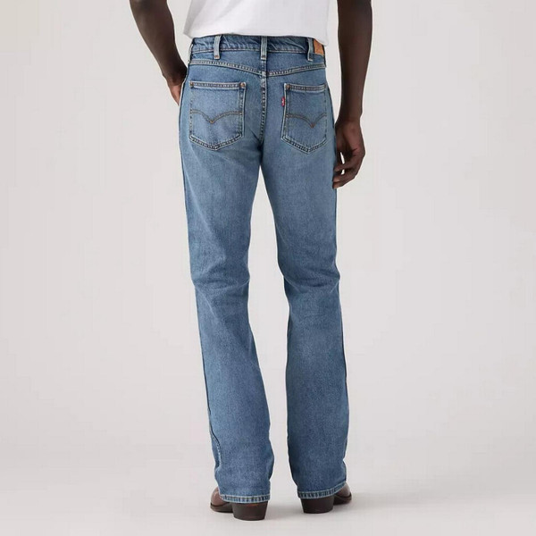 Model Wearing Levi's Men's 537 Western Bootcut Medium Wash Blue Denim Jeans in Throw The Lasso - Back