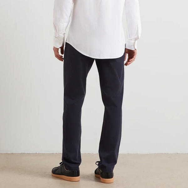 Model Wearing Farah Elm Slim Fit Organic Cotton Stretch Twill Chino Trousers in True Navy - Back Lower Half