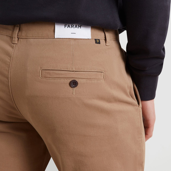 Model Wearing Farah Elm Slim Fit Organic Cotton Stretch Twill Chino Trousers in Beige - Back Pocket Close-Up