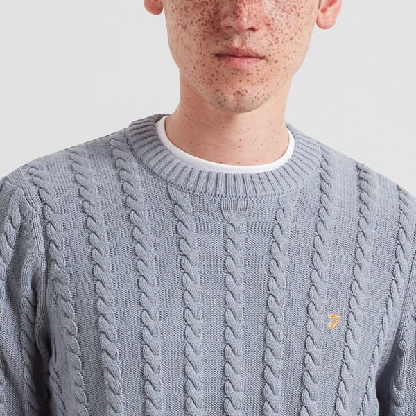 Model Wearing Farah Knight Men's Organic Cotton Retro Cable Knit Jumper in Icelandic Blue - Front Close Up