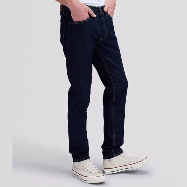 Model Wearing Lee Luke Slim Tapered Dark Indigo Denim Jeans in Rinse Raine - Side Facing