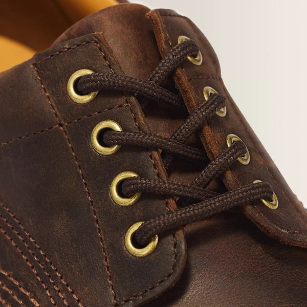 Dr. Martens Lowell Men's 4-Eye Crazy Horse Leather Moc Toe Shoes in Brown - Close up eyelets and laces