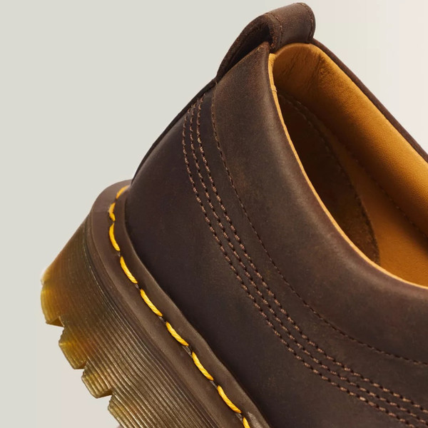 Dr. Martens Lowell Men's 4-Eye Crazy Horse Leather Moc Toe Shoes in Brown - Close up yellow welt stitch