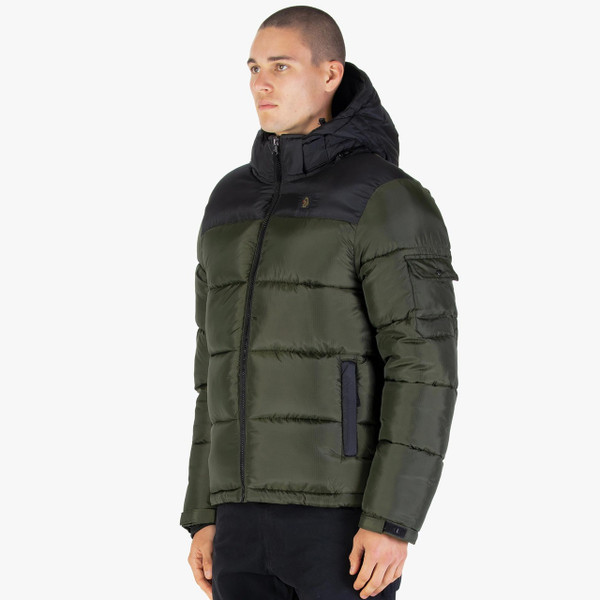 Model Wearing Luke 1977 Yupick Retro 80s Hooded Puffer Jacket in Dark Green - Side Facing