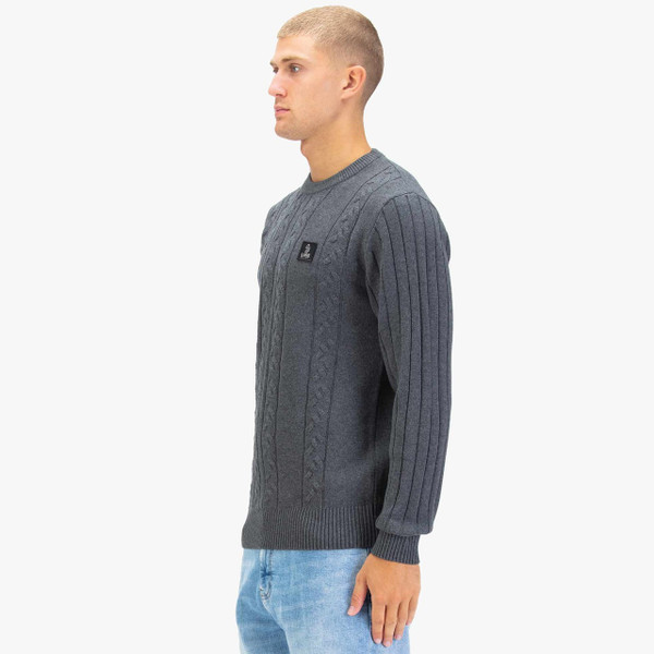 Model Wearing Luke 1977 Mitcham Men's Cable Knit Jumper in Charcoal - Side On