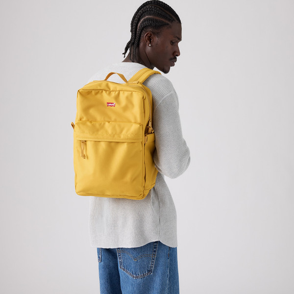 Model Wearing the Levi's L Pack Standard Laptop Backpack in Cool Yellow