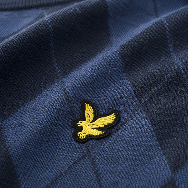 Golden Eagle badge and diamond pattern on the Lyle & Scott Cotton Merino Argyle Knit Jumper in Dark Navy Marl