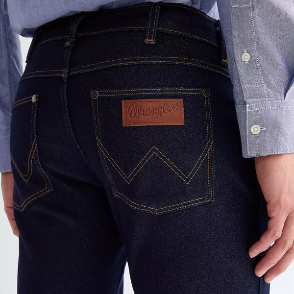 Model Wearing Wrangler Men's Greensboro Straight Fit Epic Soft Jeans in Moonlight Rinse - Close up back pocket