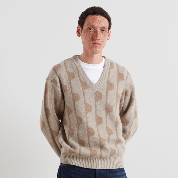 Model Wearing Farah Glynn Men's Relaxed V-Neck Geo Jacquard Jumper in Putty - Front facing